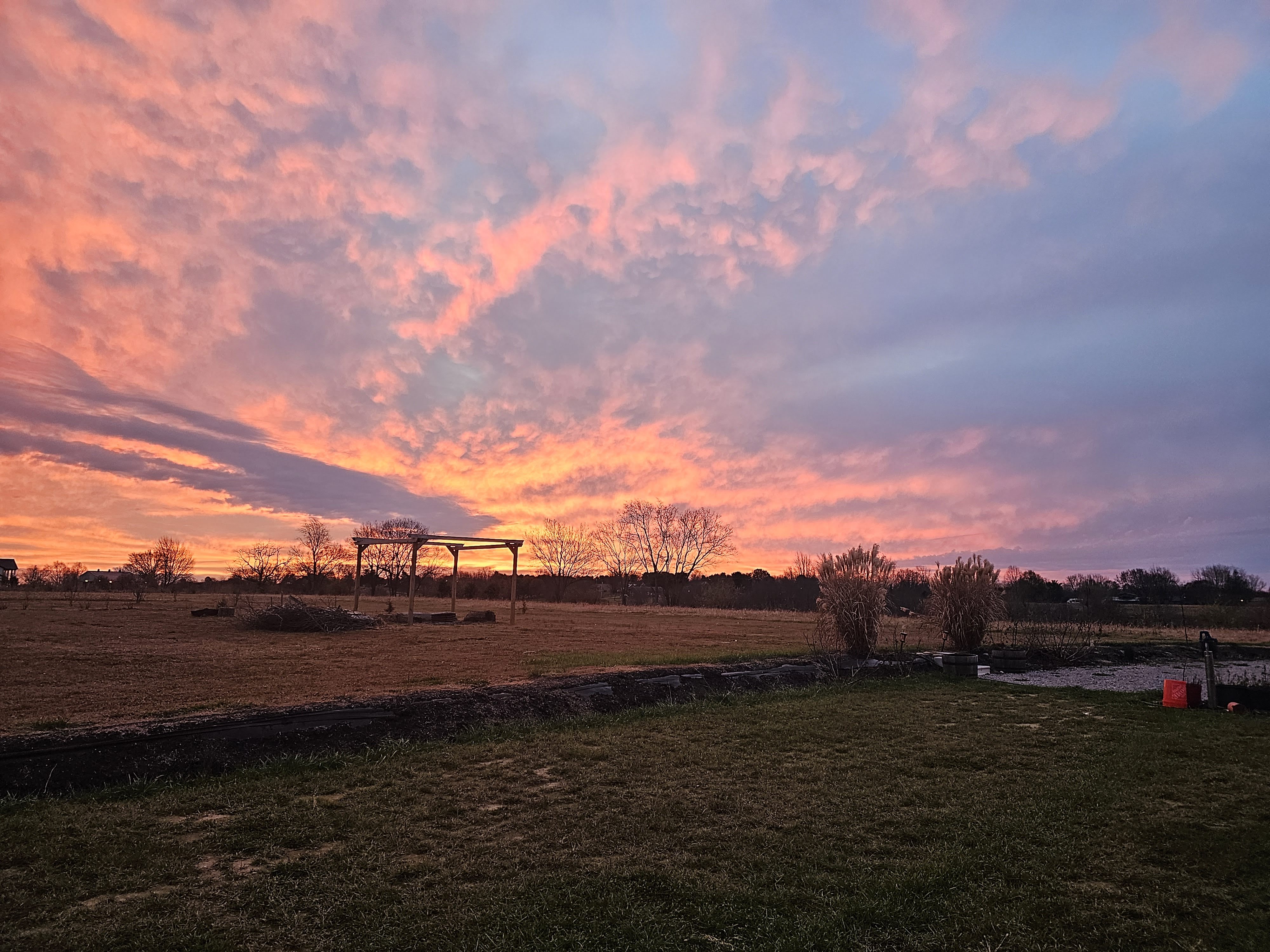Kentucky property with pergola frame under a fiery sunset