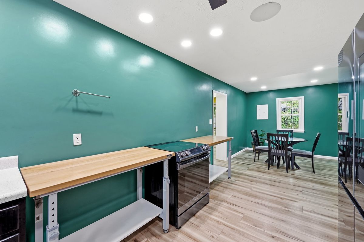 Kitchen with butcher block counter, range, and stainless refrigerator