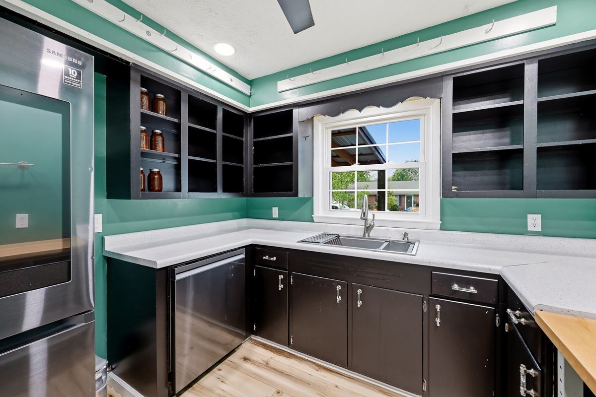 Kitchen cabinets with open shelving and stainless appliances