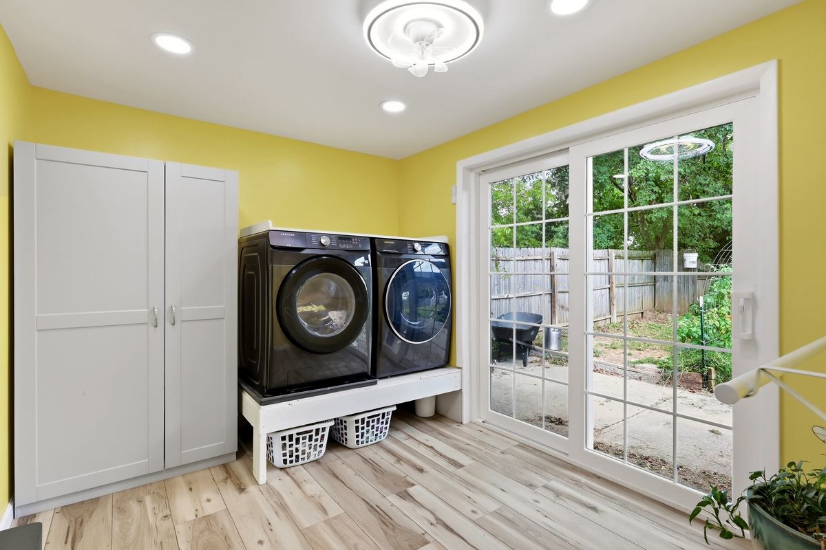 Laundry room with front-load washer and dryer, pantry closet, and French doors to backyard