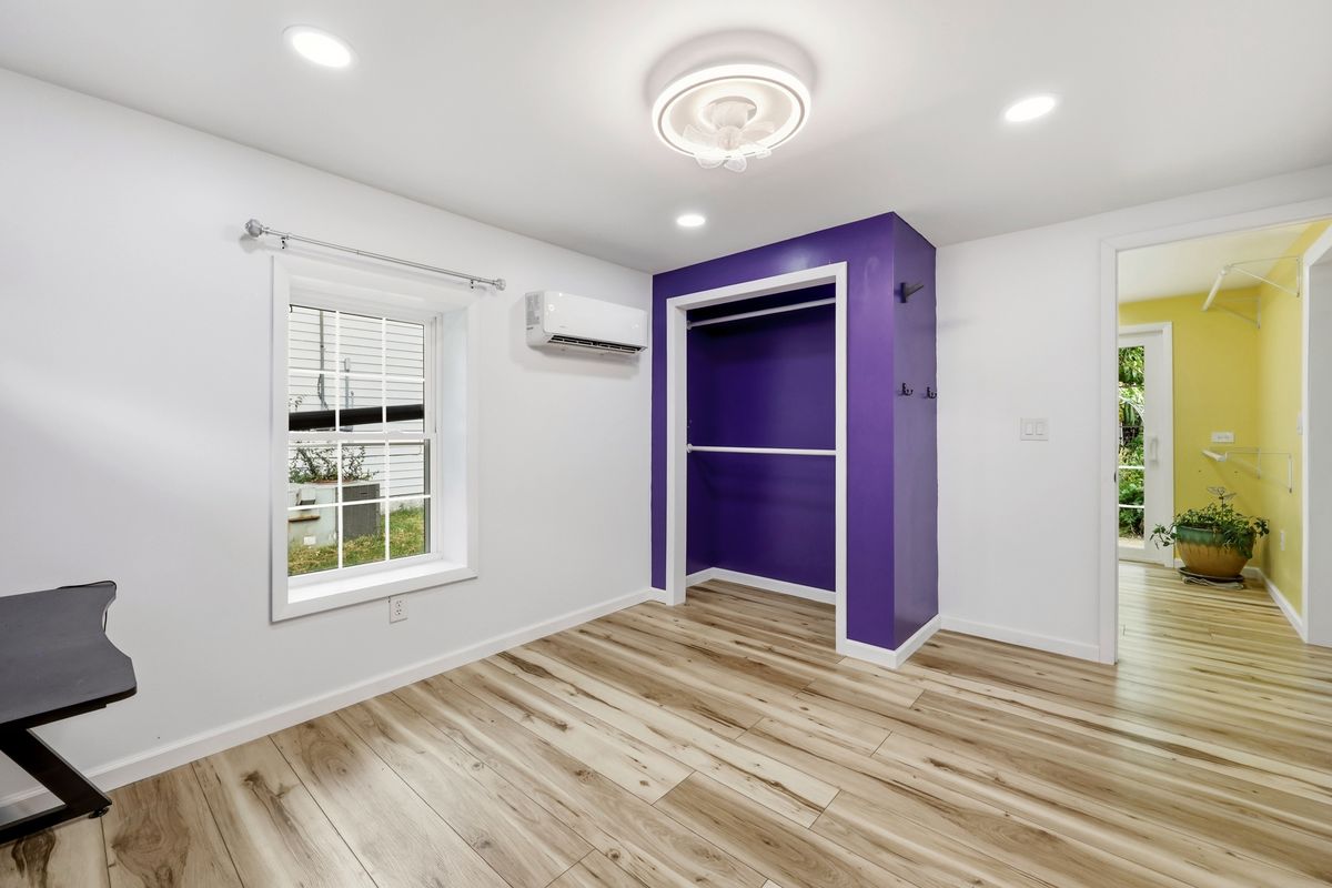 Addition bedroom showing closet, mini split, and view to laundry room