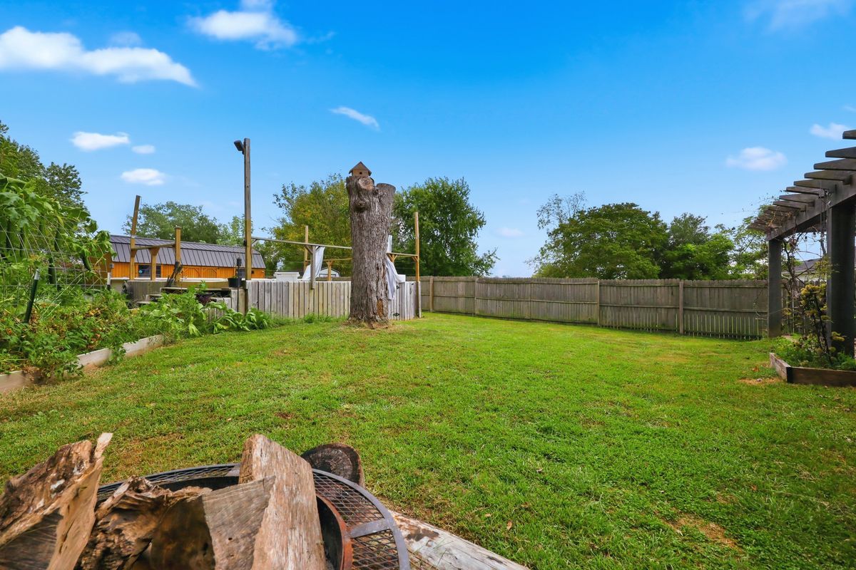 Privacy-fenced backyard with fire pit