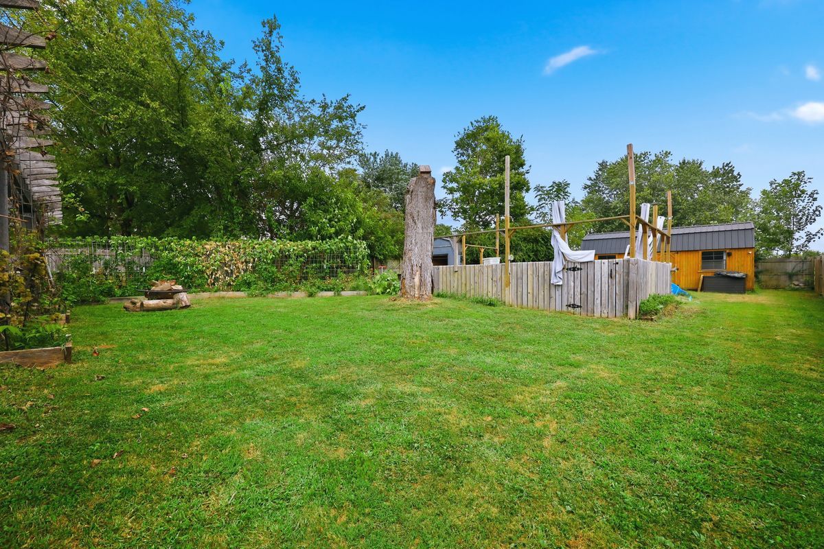 Backyard with detached shed and pool deck