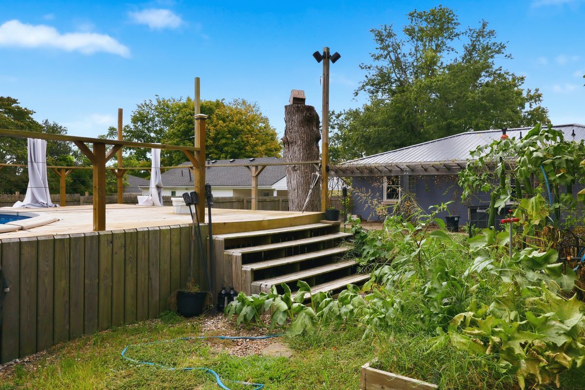 Pool deck with steps and garden beds below