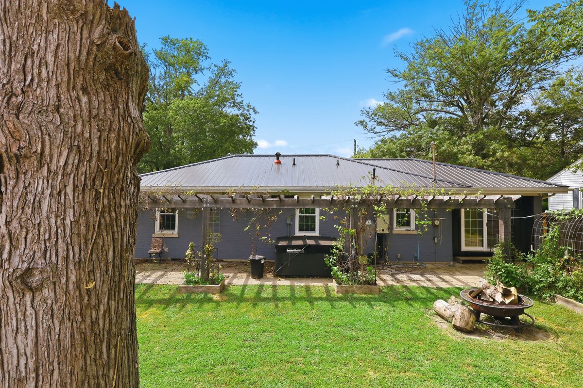 Back of home showing 2025 metal roof and pergola