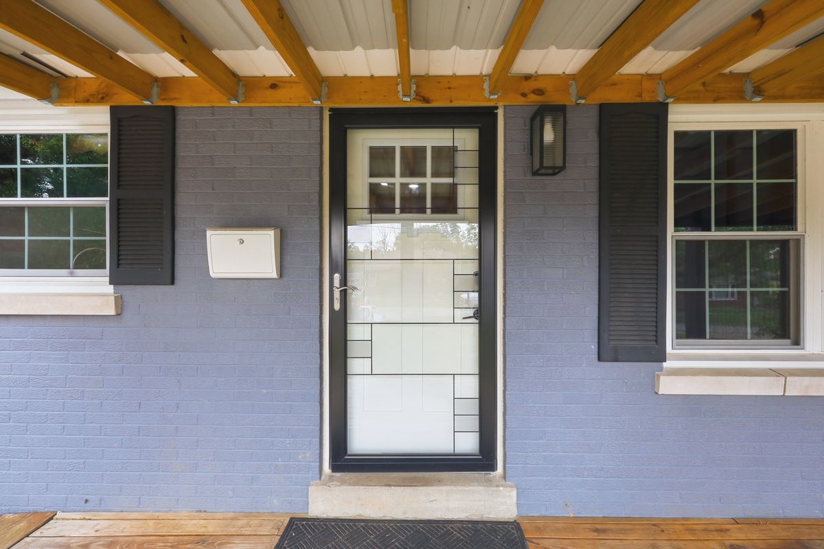 Covered front porch with natural wood ceiling