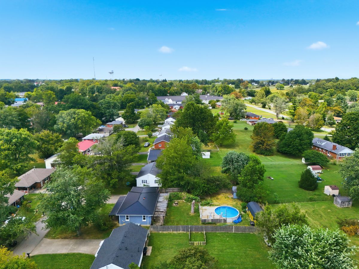 Wide aerial of Lancaster neighborhood with rolling green hills