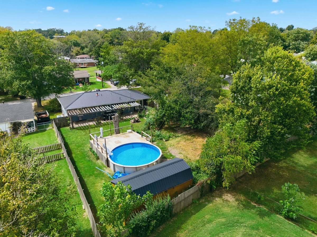 Aerial showing backyard, pool, deck, pergola, and shed