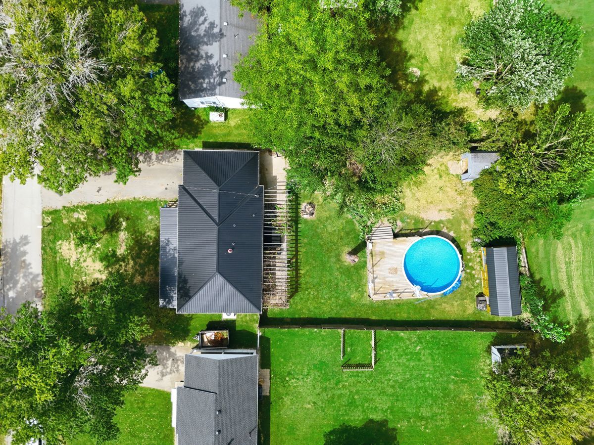 Bird's-eye view of entire property with home, pool, and yard