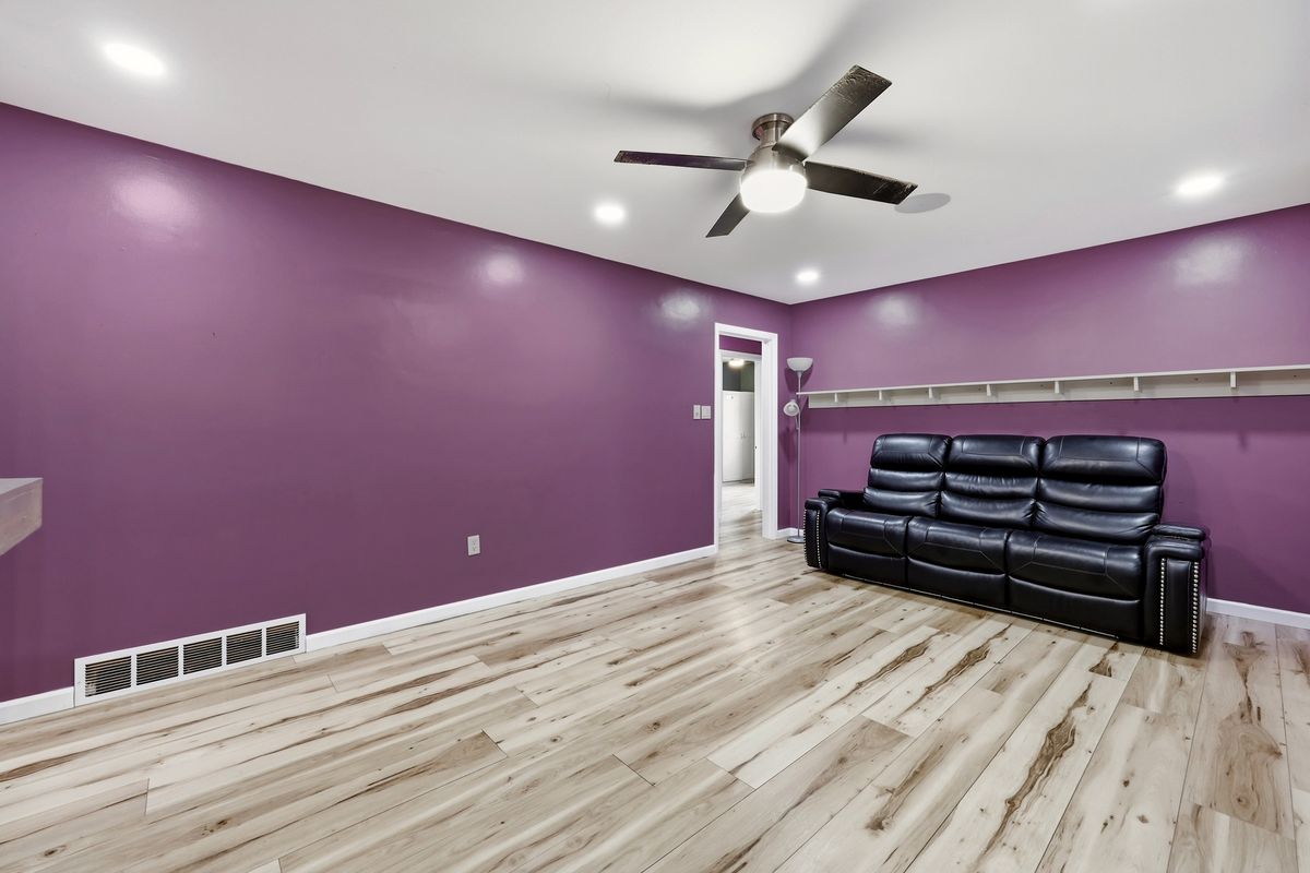 Living room with recessed lighting, ceiling fan, and vinyl plank floors