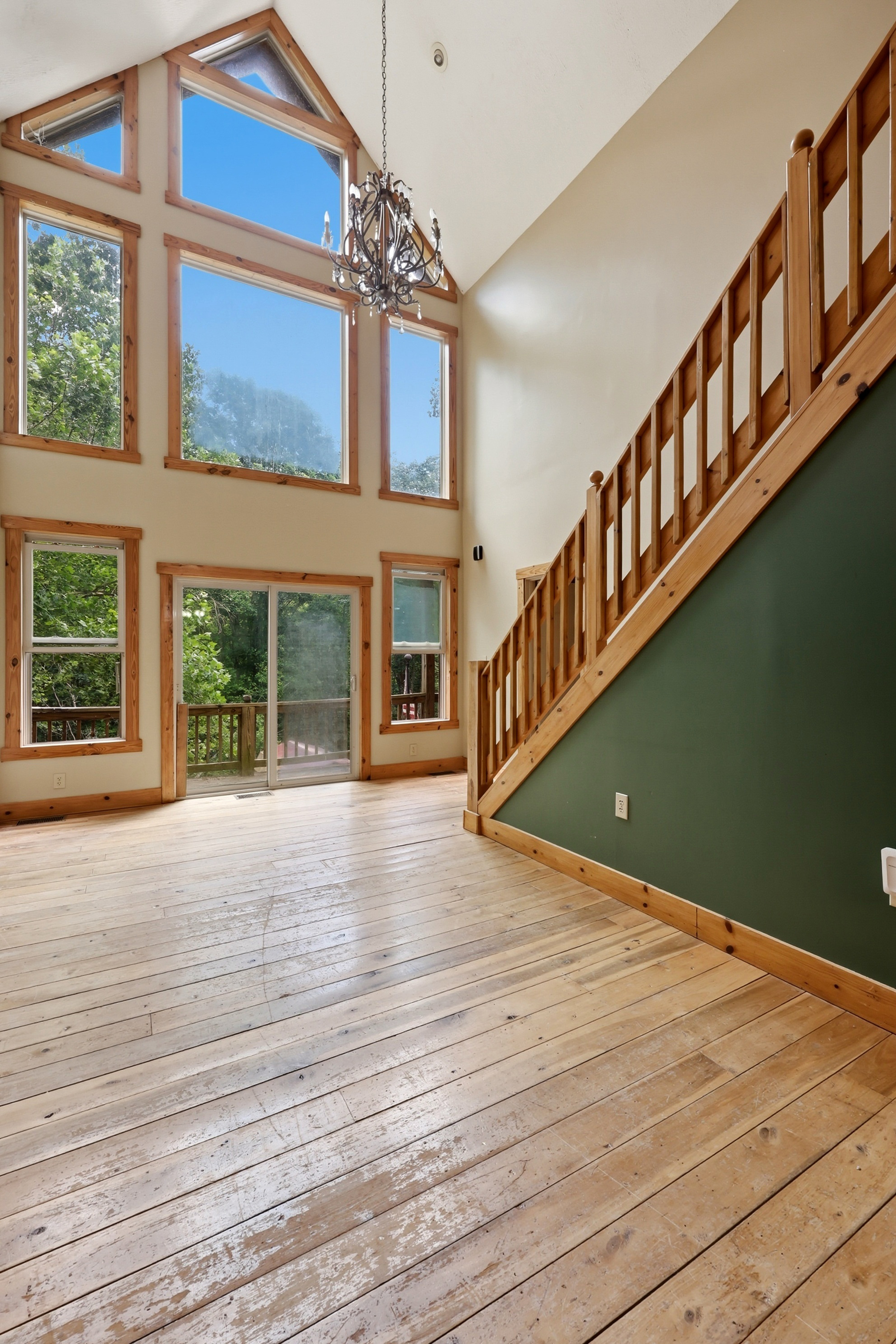 Two-story entry with floor-to-ceiling windows and open staircase