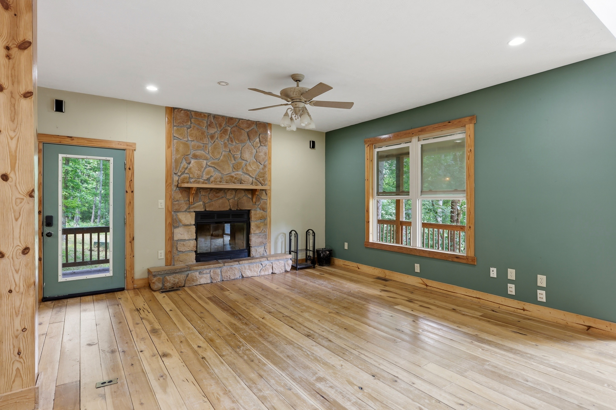 Living room with stone wood-burning fireplace