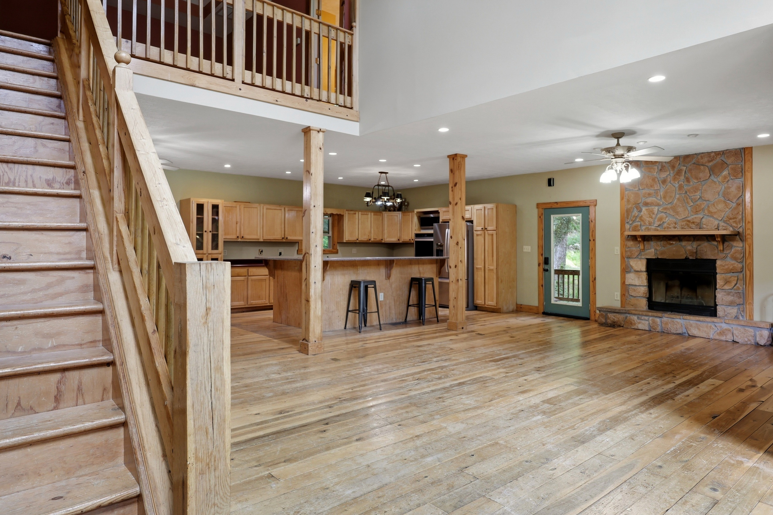 Main level wide view with staircase and kitchen