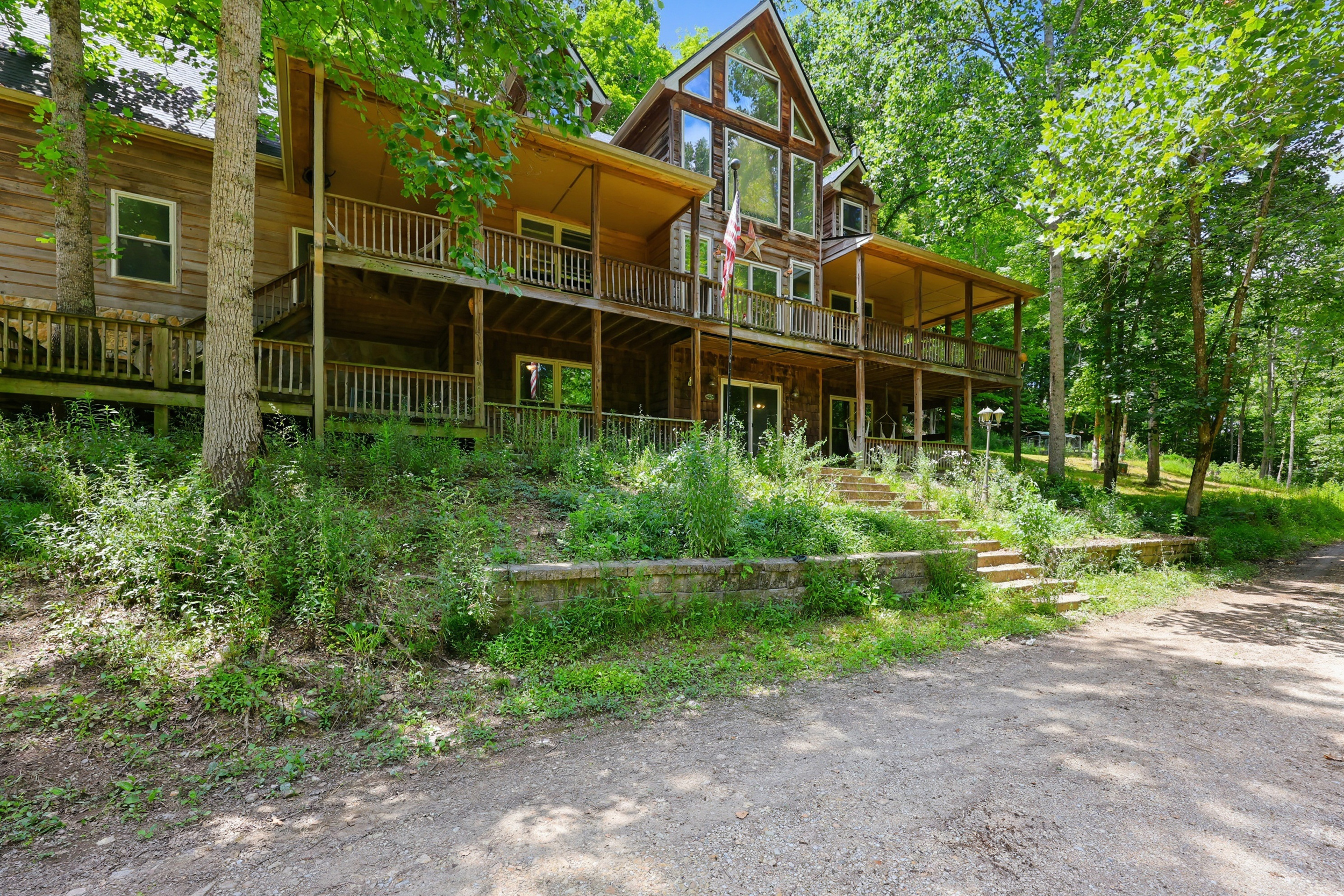 Home exterior from driveway with wraparound porches