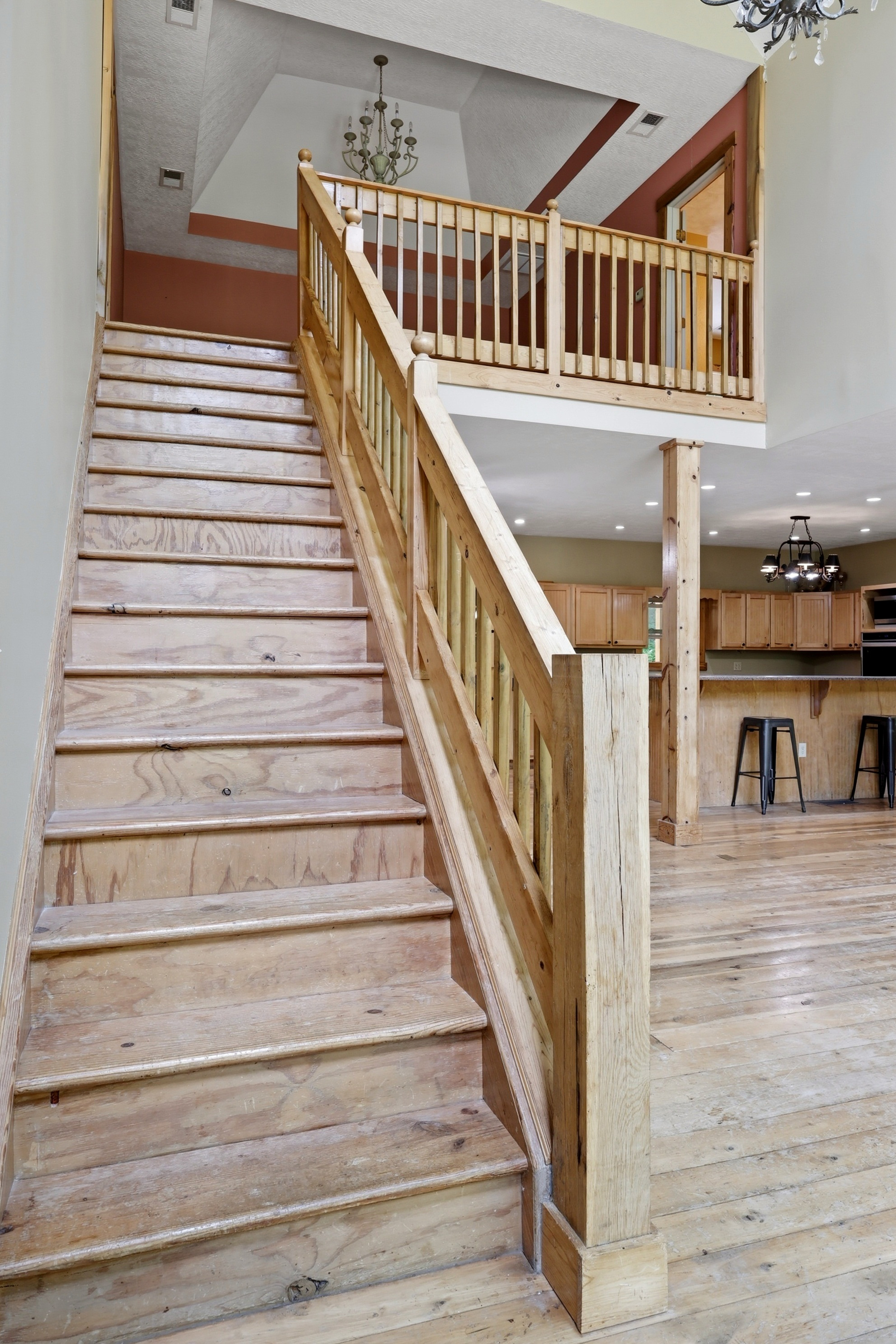 Open staircase with upper balcony overlook