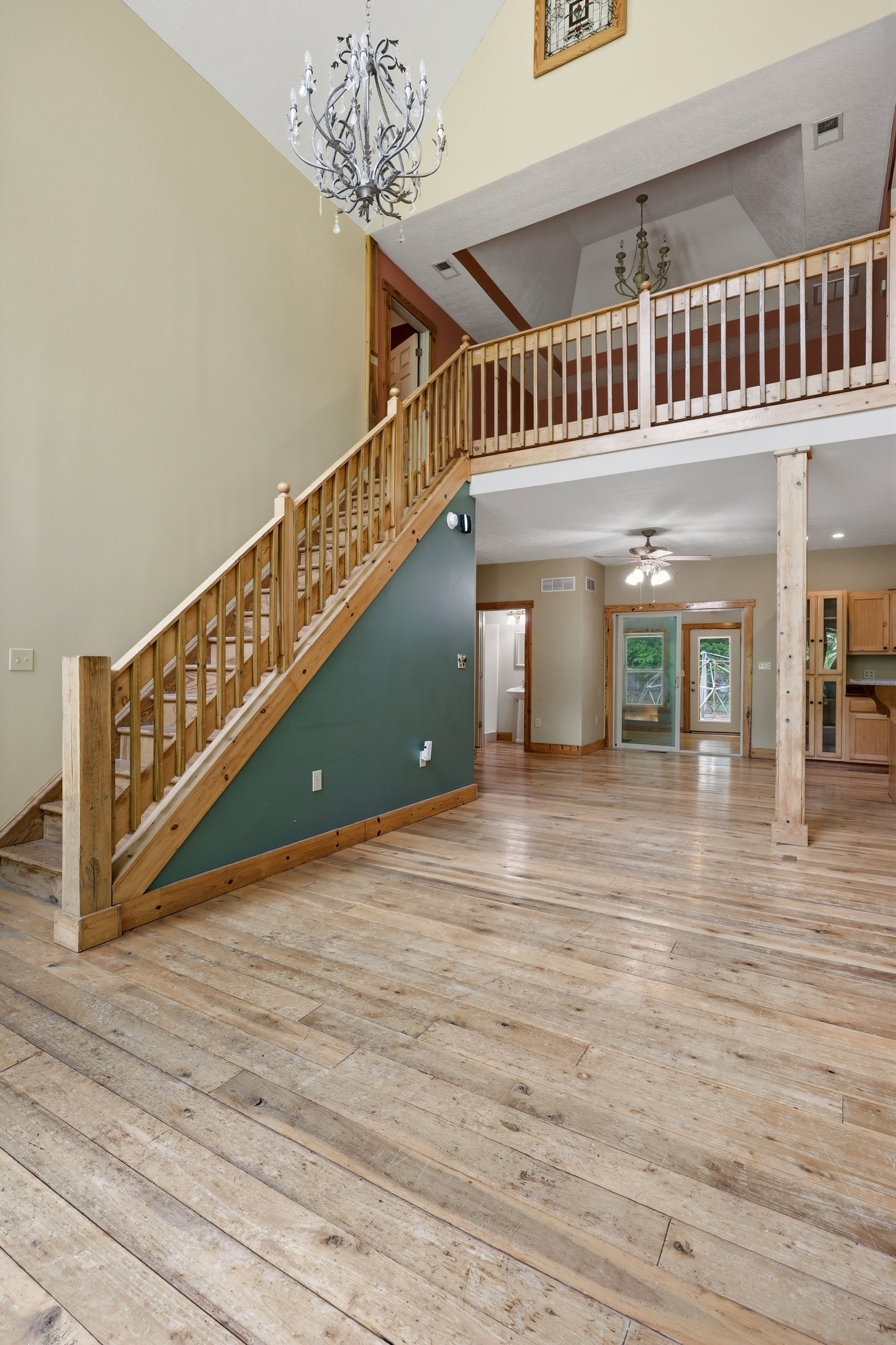 Two-story entry with chandelier and staircase
