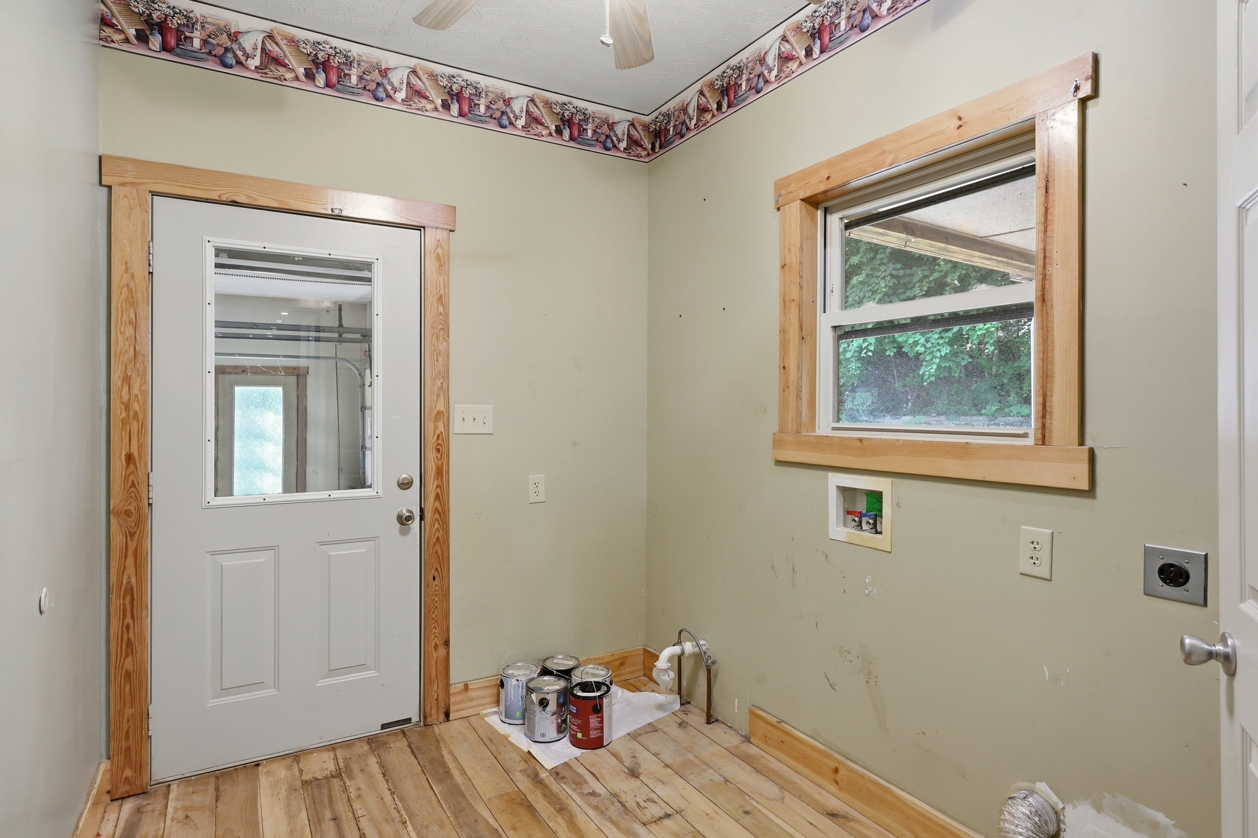 Utility and laundry room with exterior door