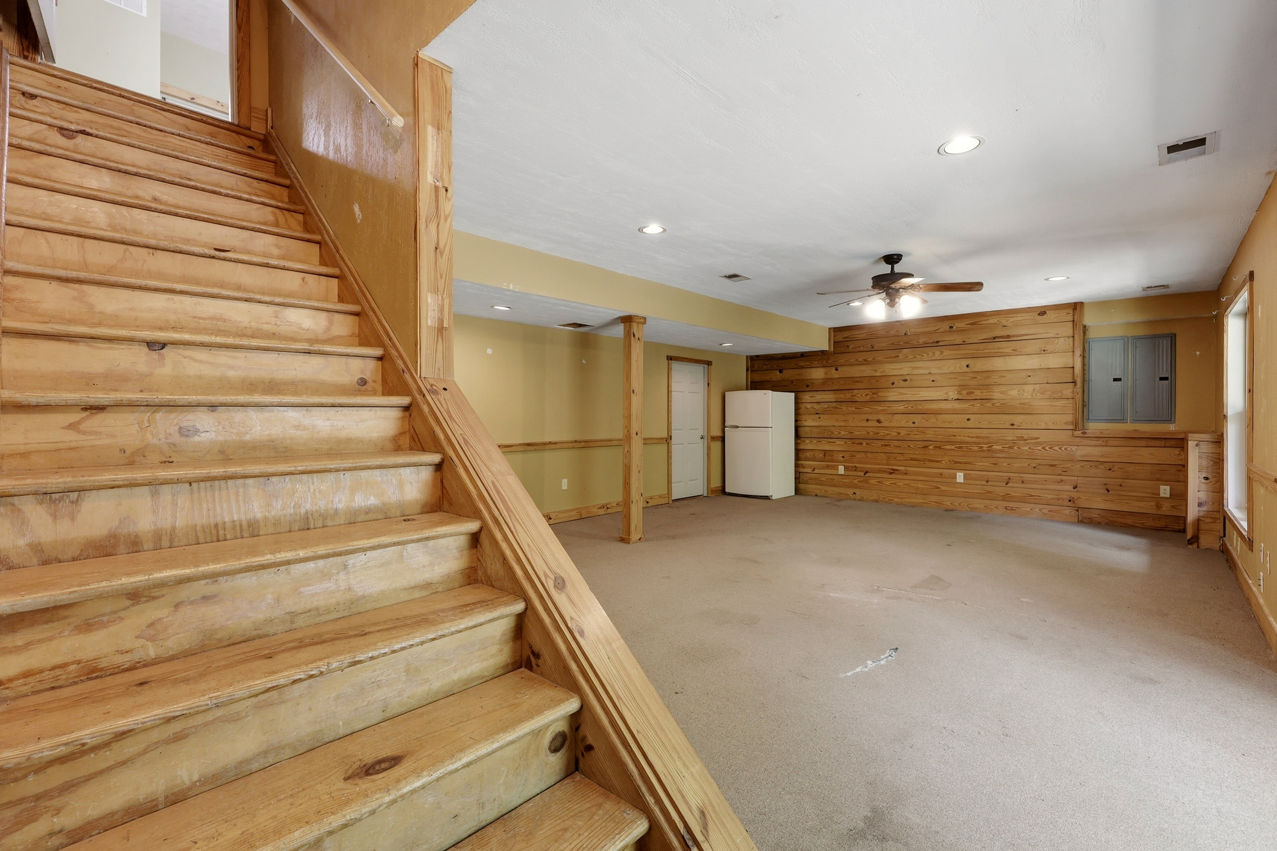Basement with staircase and rec room