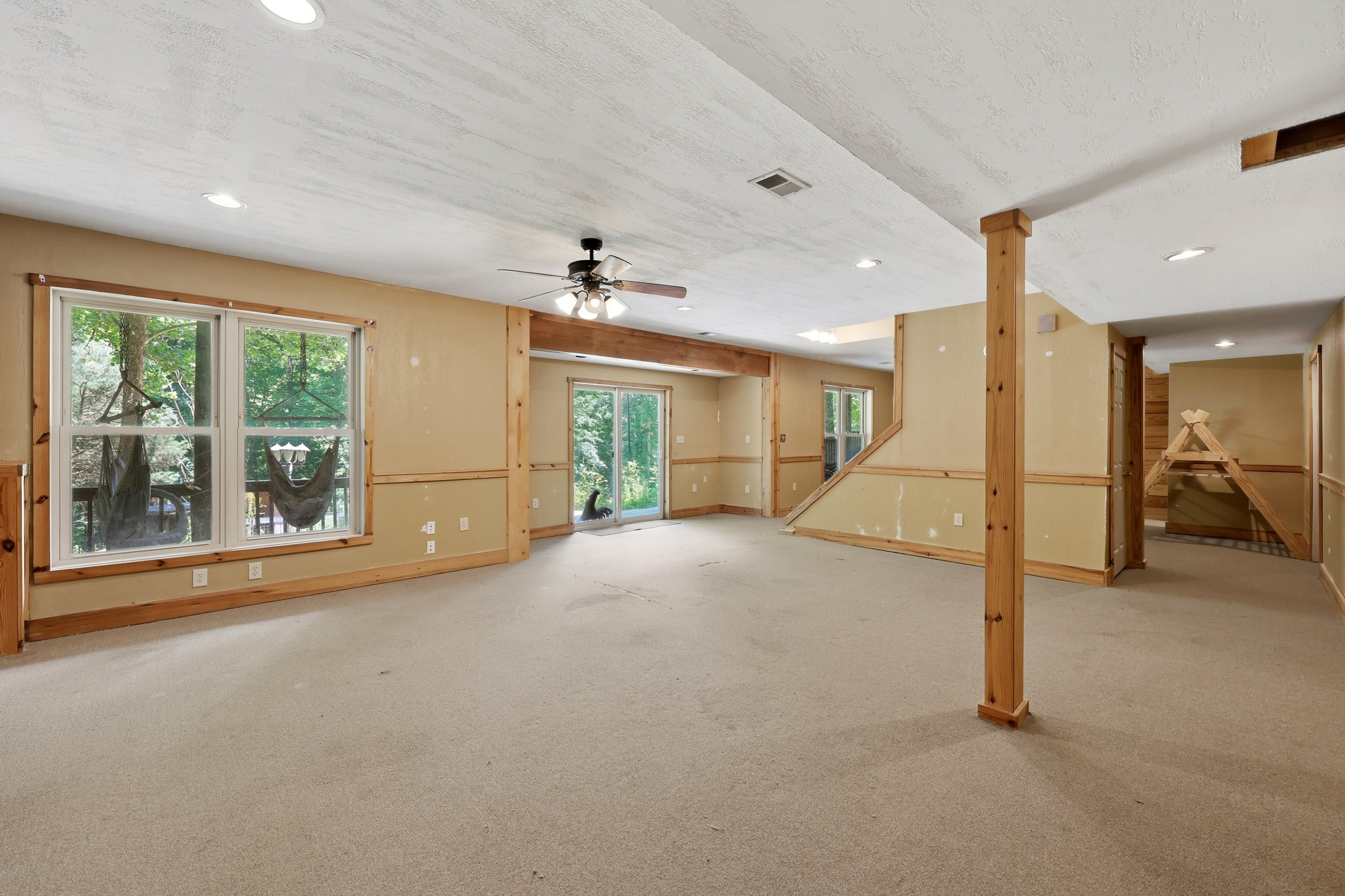 Large basement recreational room with windows