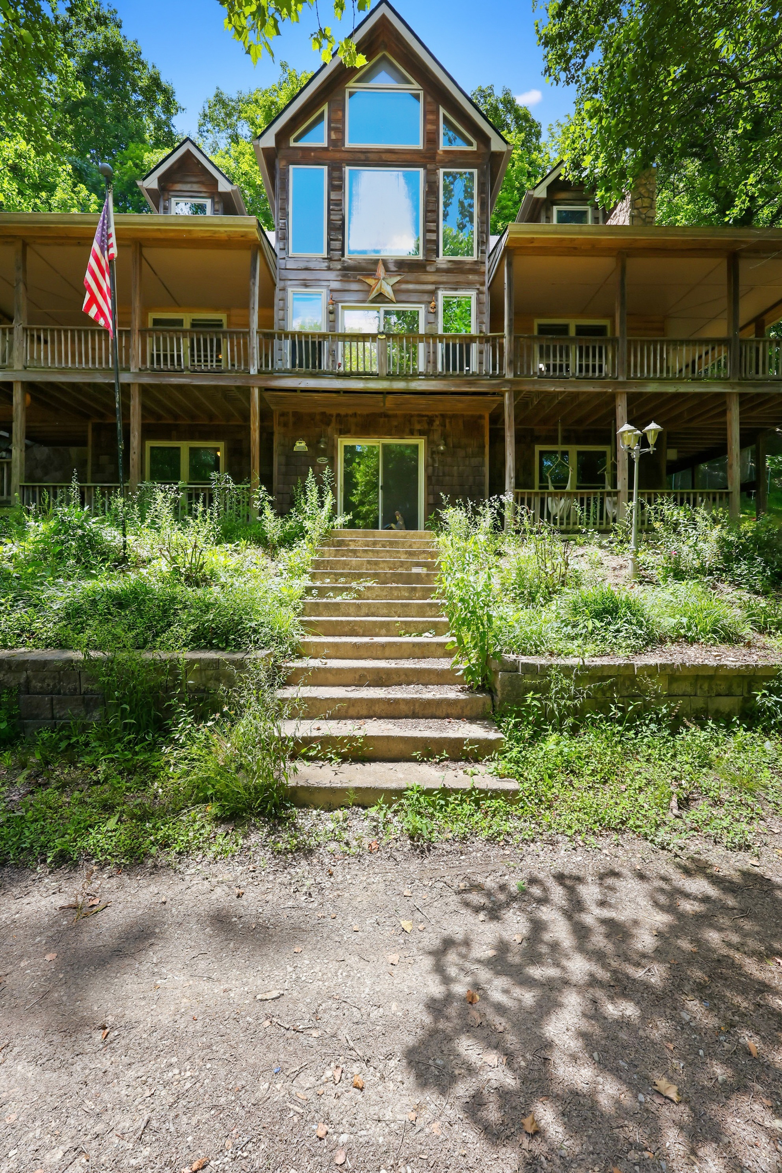 Front entrance with stone steps and cypress siding