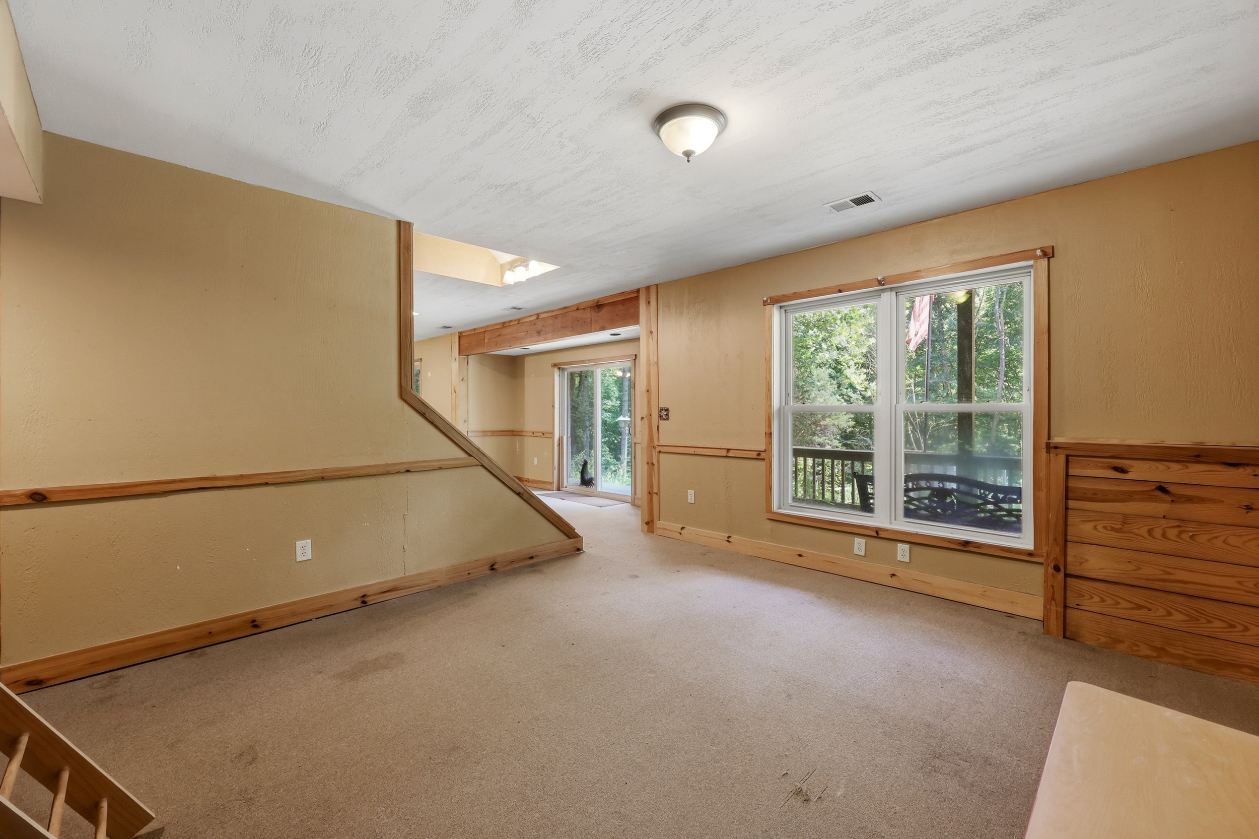 Upper level sitting area with tree-top views