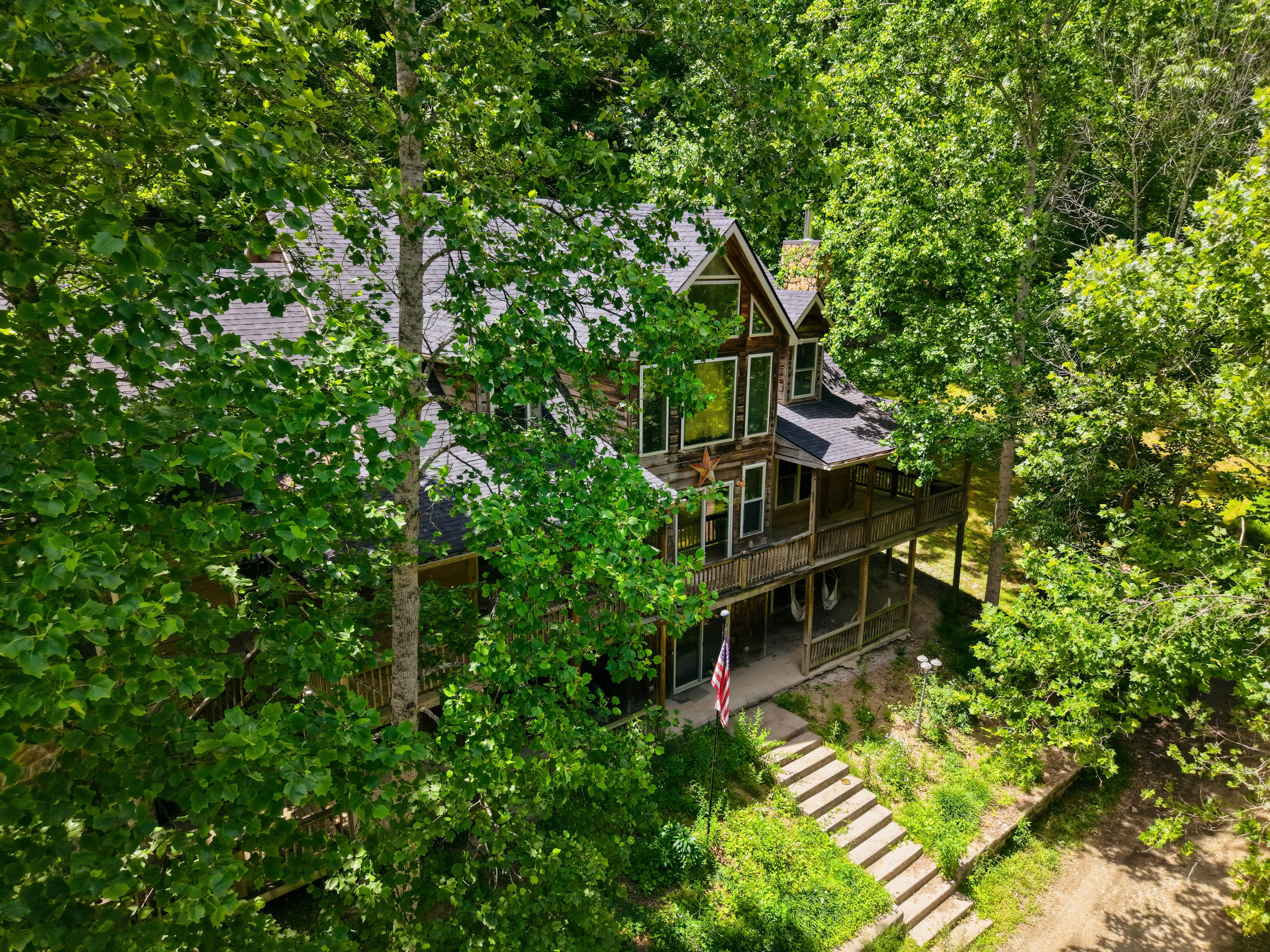 Aerial view of secluded home nestled in trees in Bradfordsville, Kentucky