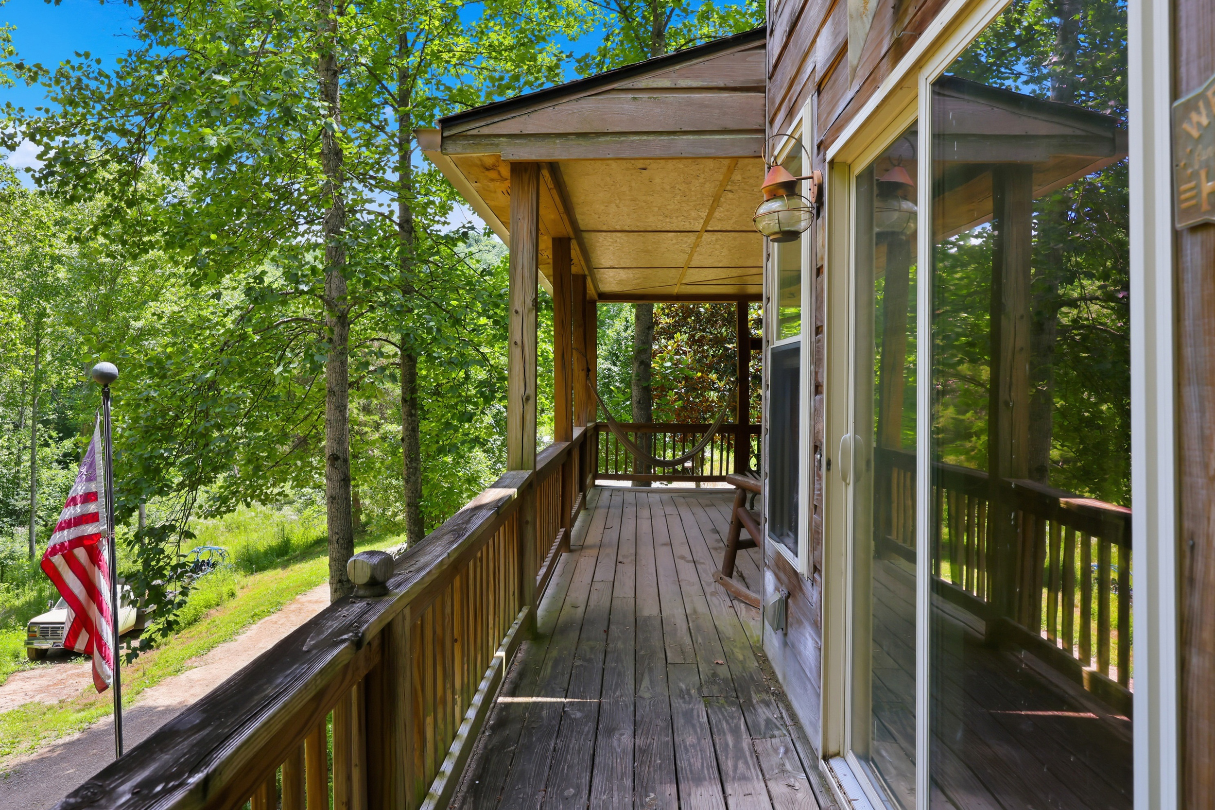 Wraparound porch with American flag