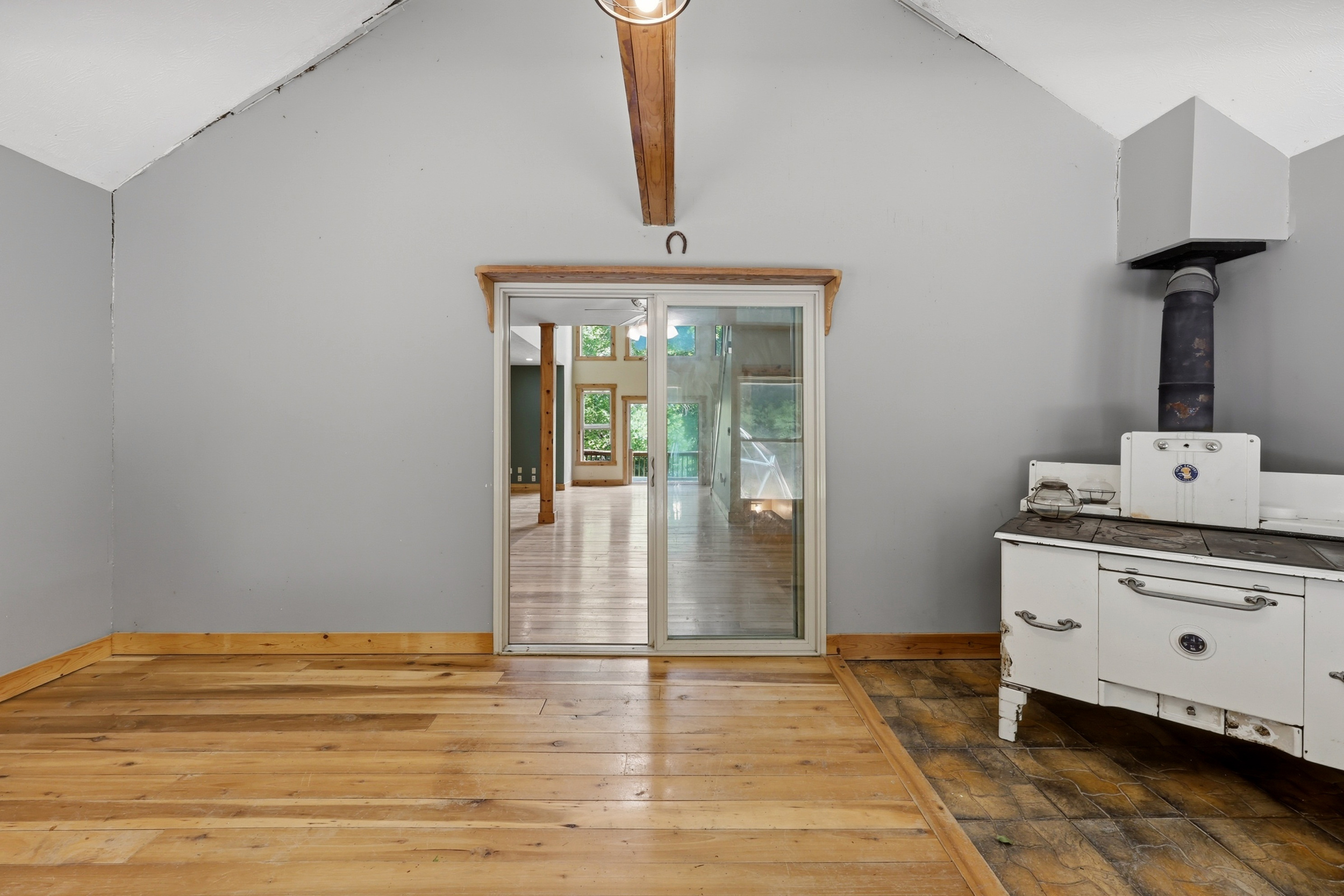 Sunroom with vintage wood stove and sliding door