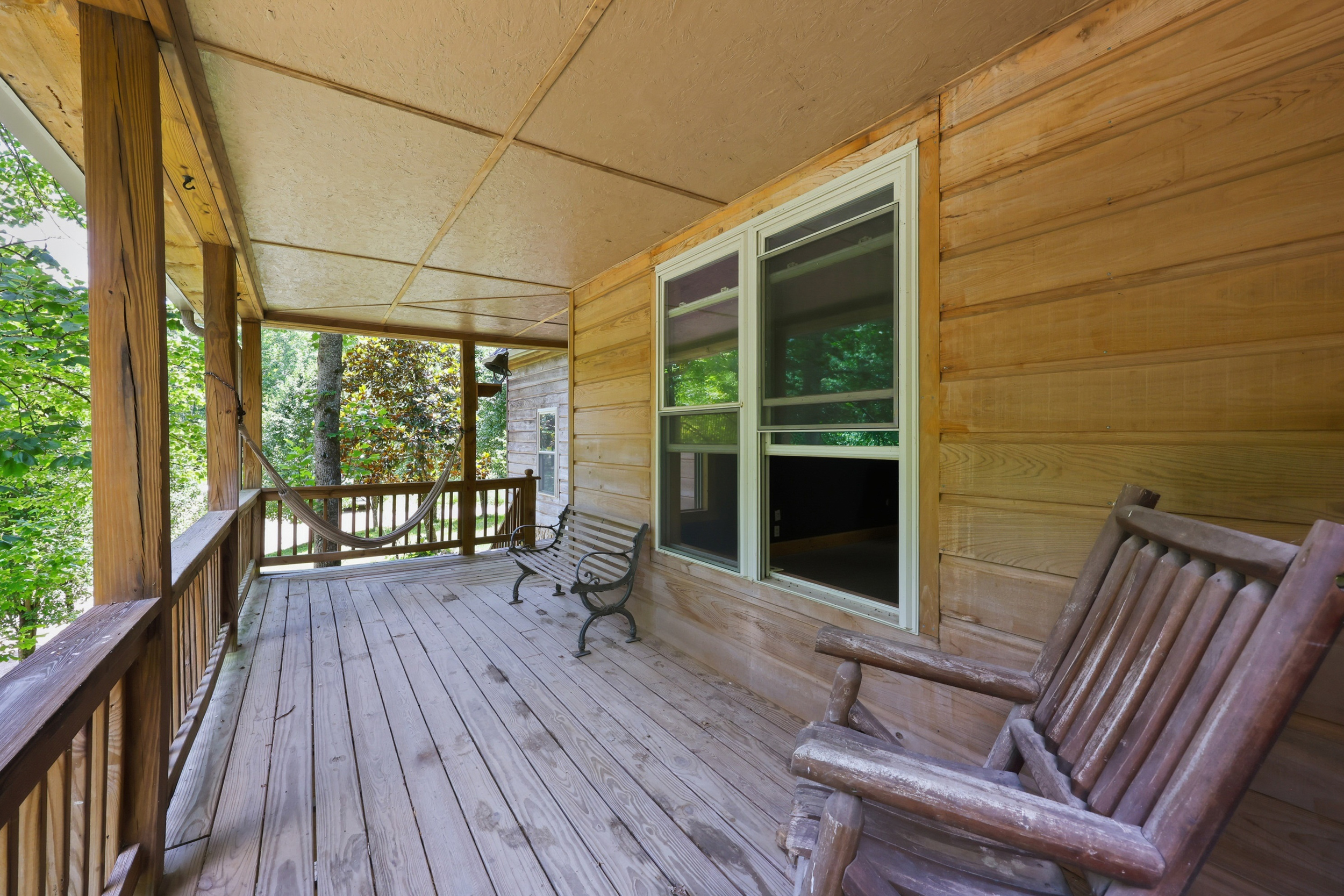 Covered porch with seating and wooded views