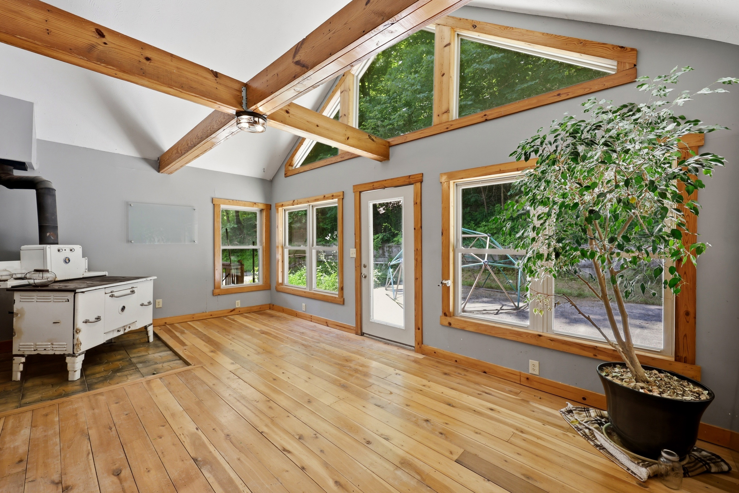 Sunroom with exposed beams and windows