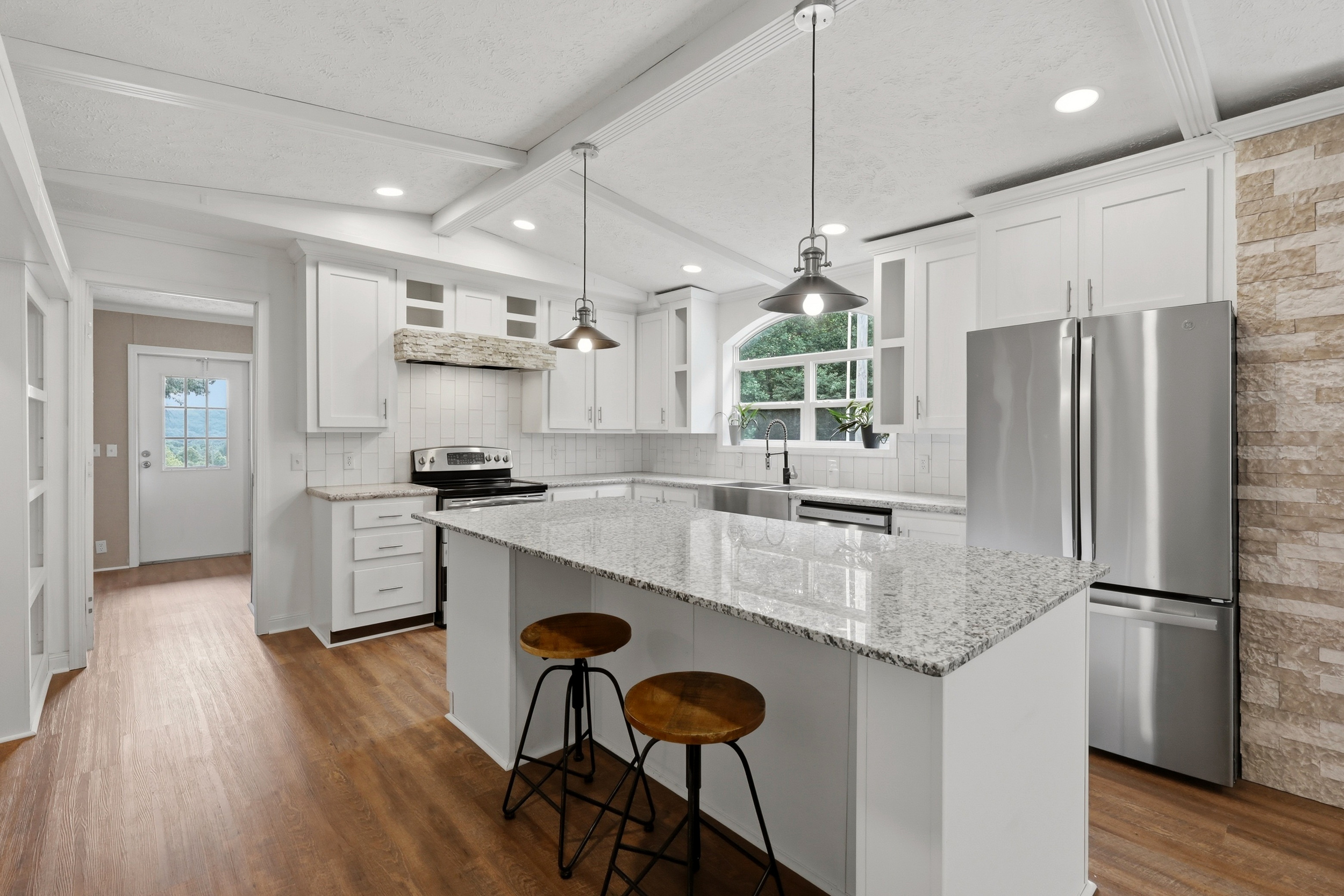 Kitchen with granite island and pendant lights