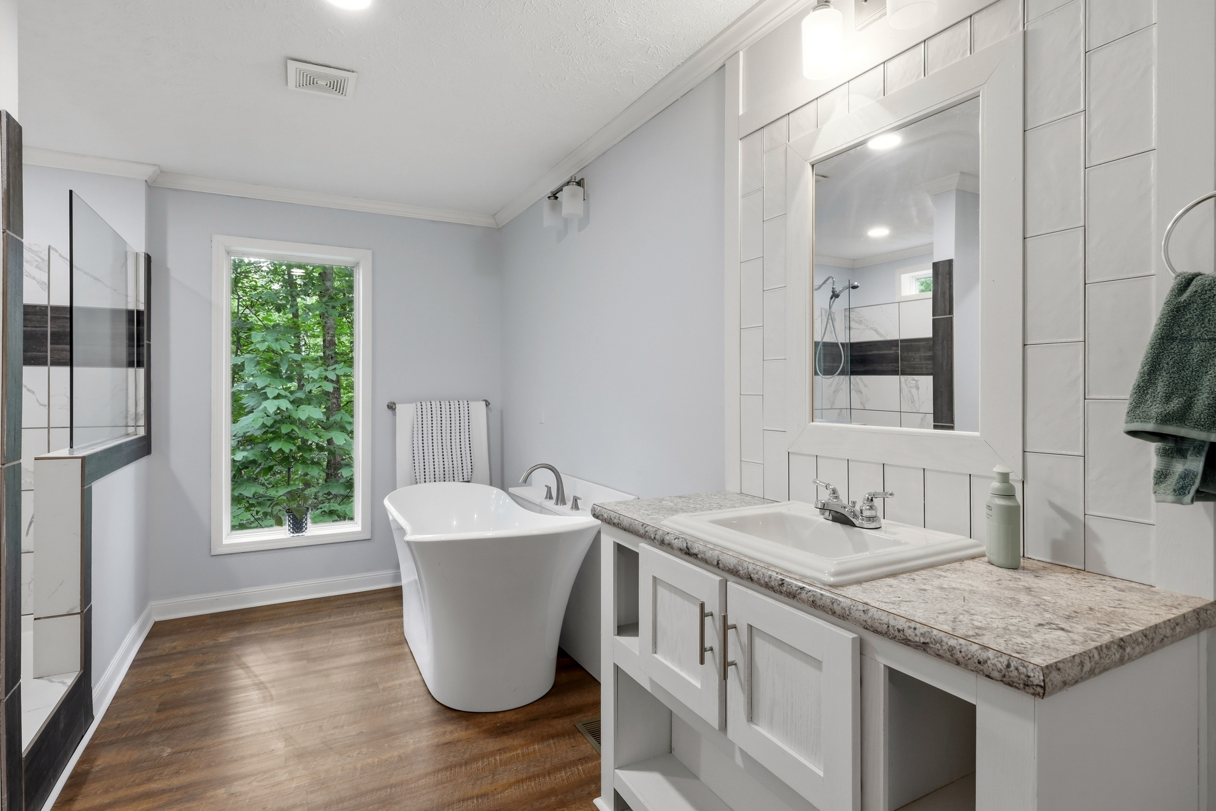 Primary bathroom with soaking tub and tiled shower