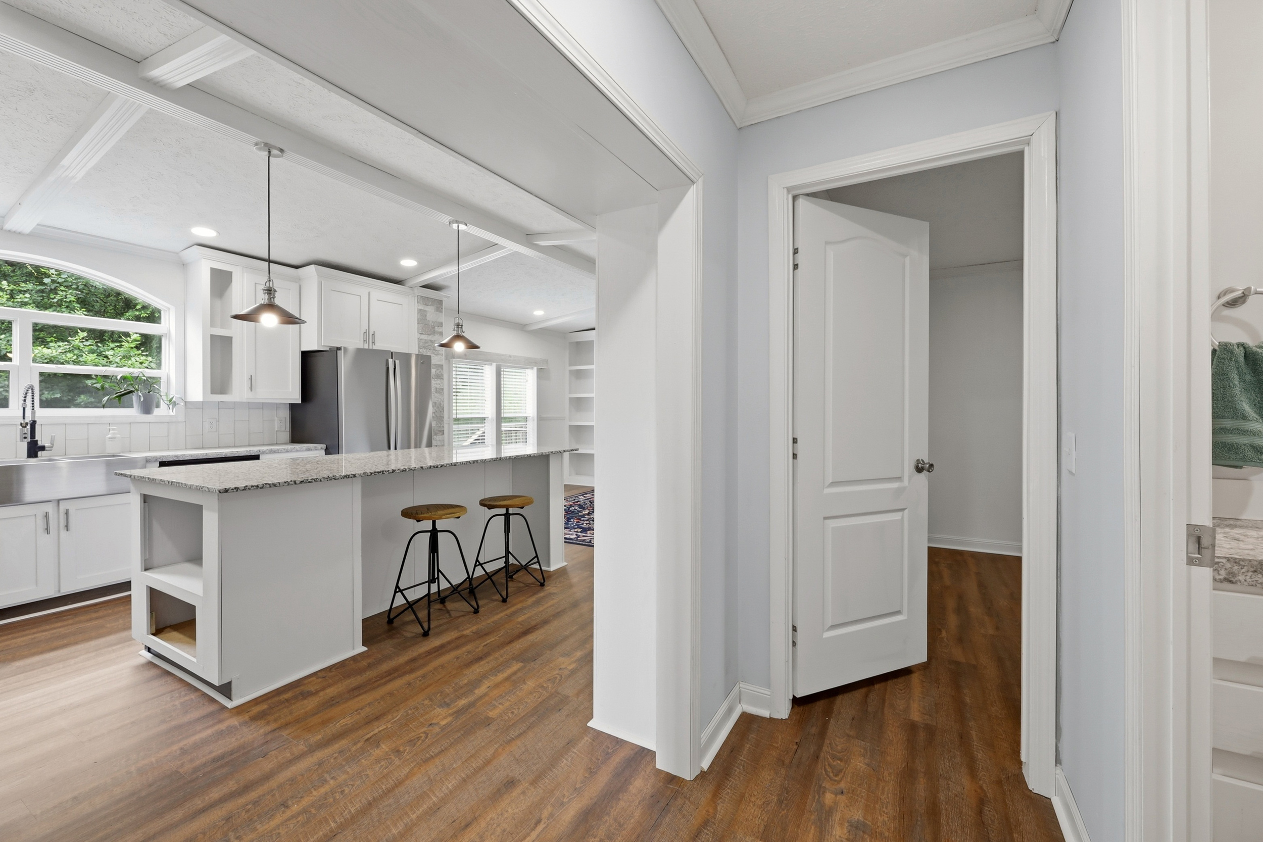 Kitchen from hallway showing island and living room