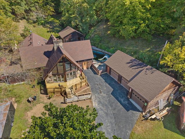 Aerial view of the property and surrounding wooded acreage
