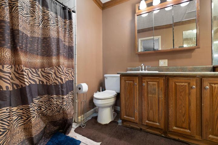 Remodeled primary bath with walk-in shower, new tile, and soaking tub