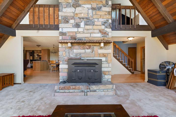 Great room looking toward the wall of windows with skylights above