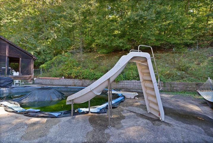 Pool area with screened pool house and landscaping