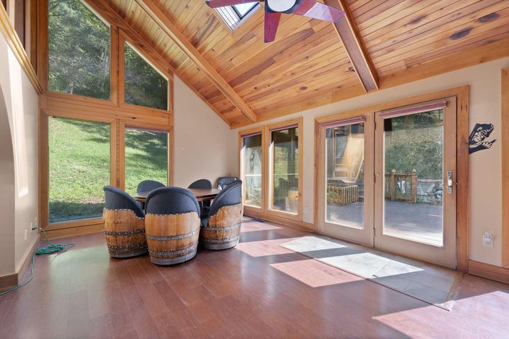 Sunroom with windows overlooking the property