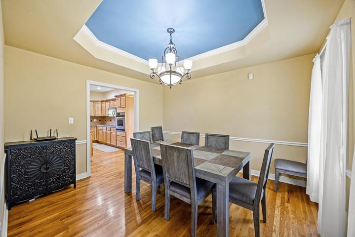 Open living room with soaring ceilings and hardwood floors
