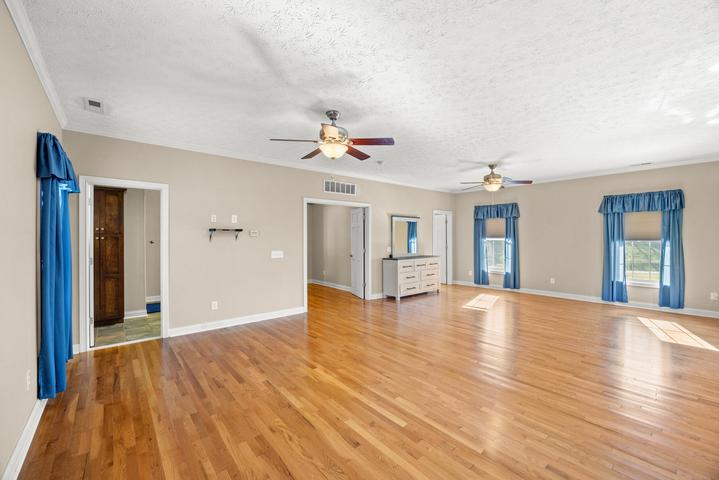 Primary bedroom from a second angle showing spacious layout