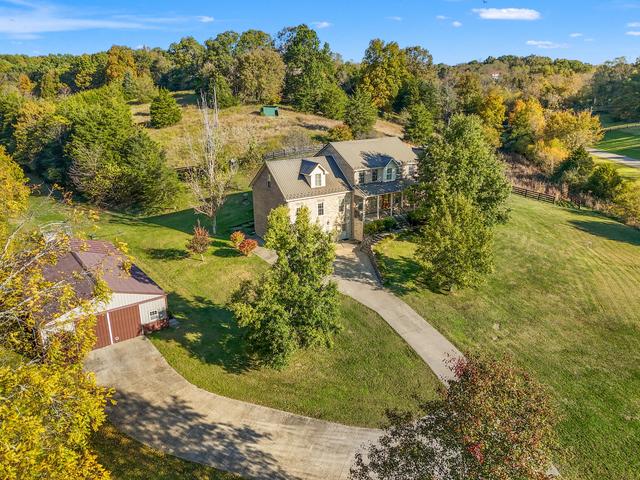 View across the acreage with open pasture and tree line