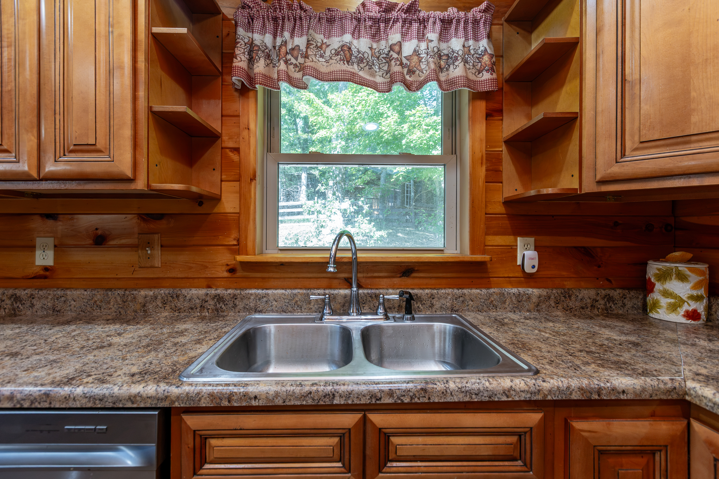 Kitchen sink with granite counter and window view
