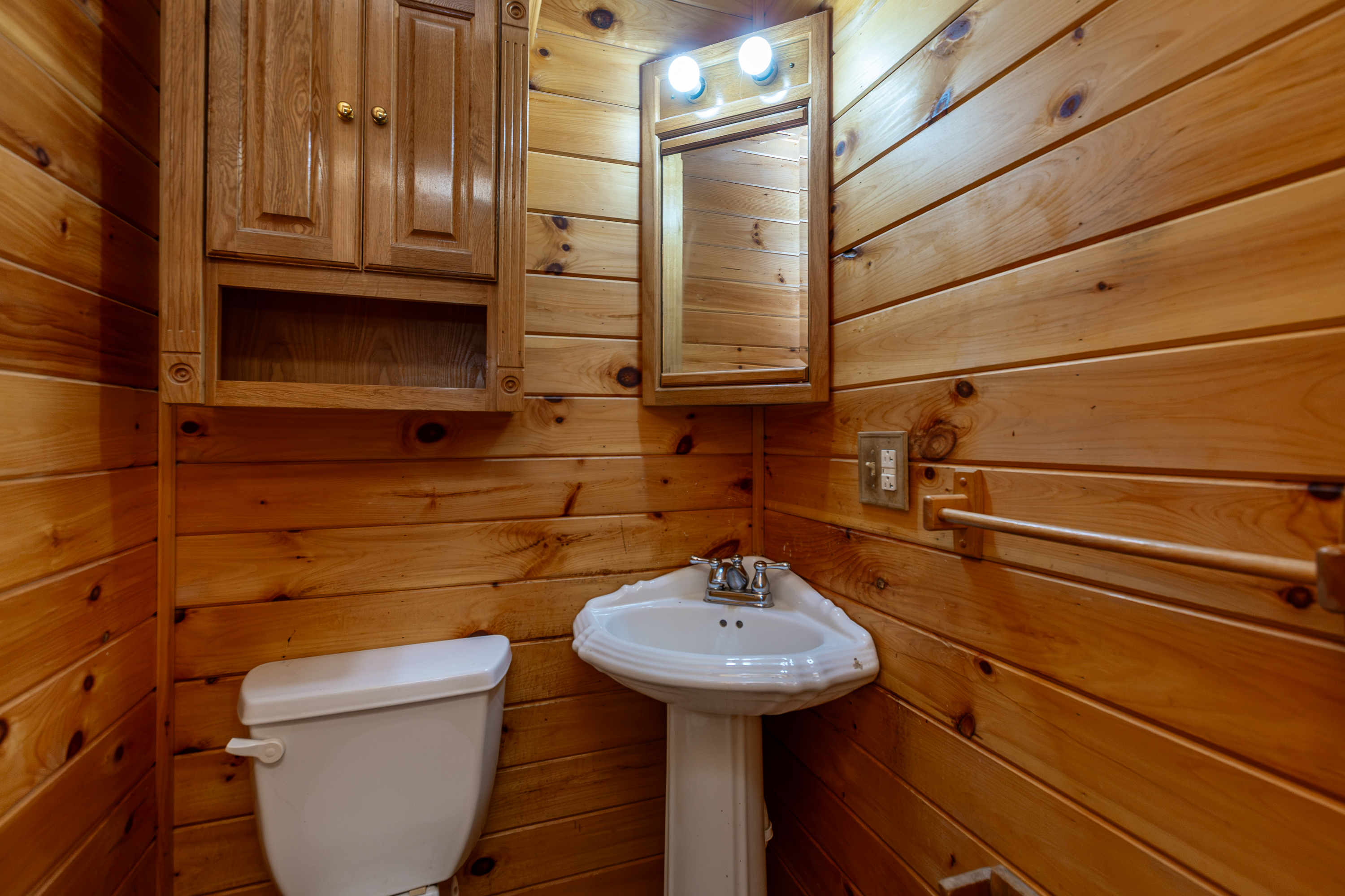 Bedroom with log walls and ceiling fan