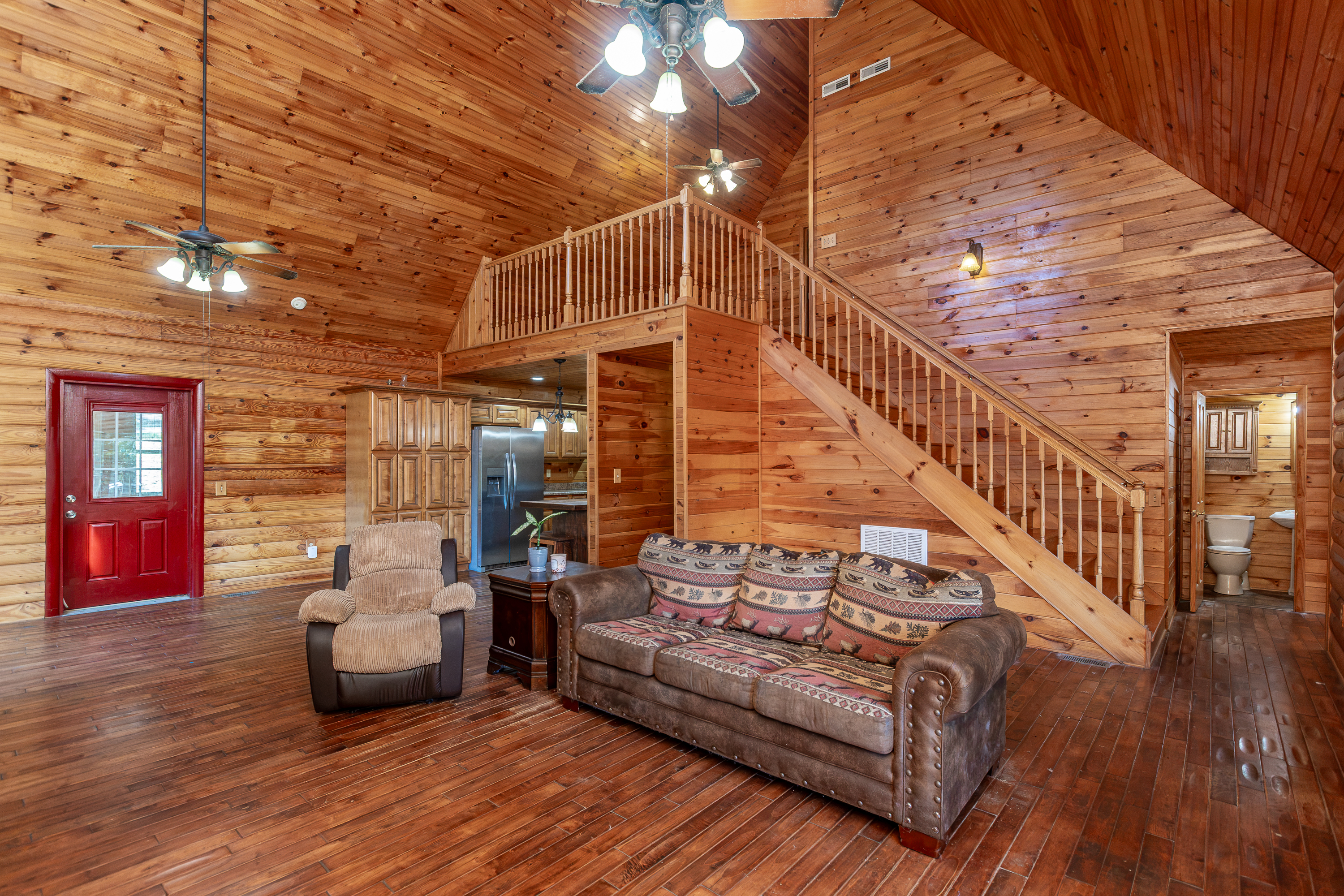 Open living area with log walls and high ceilings