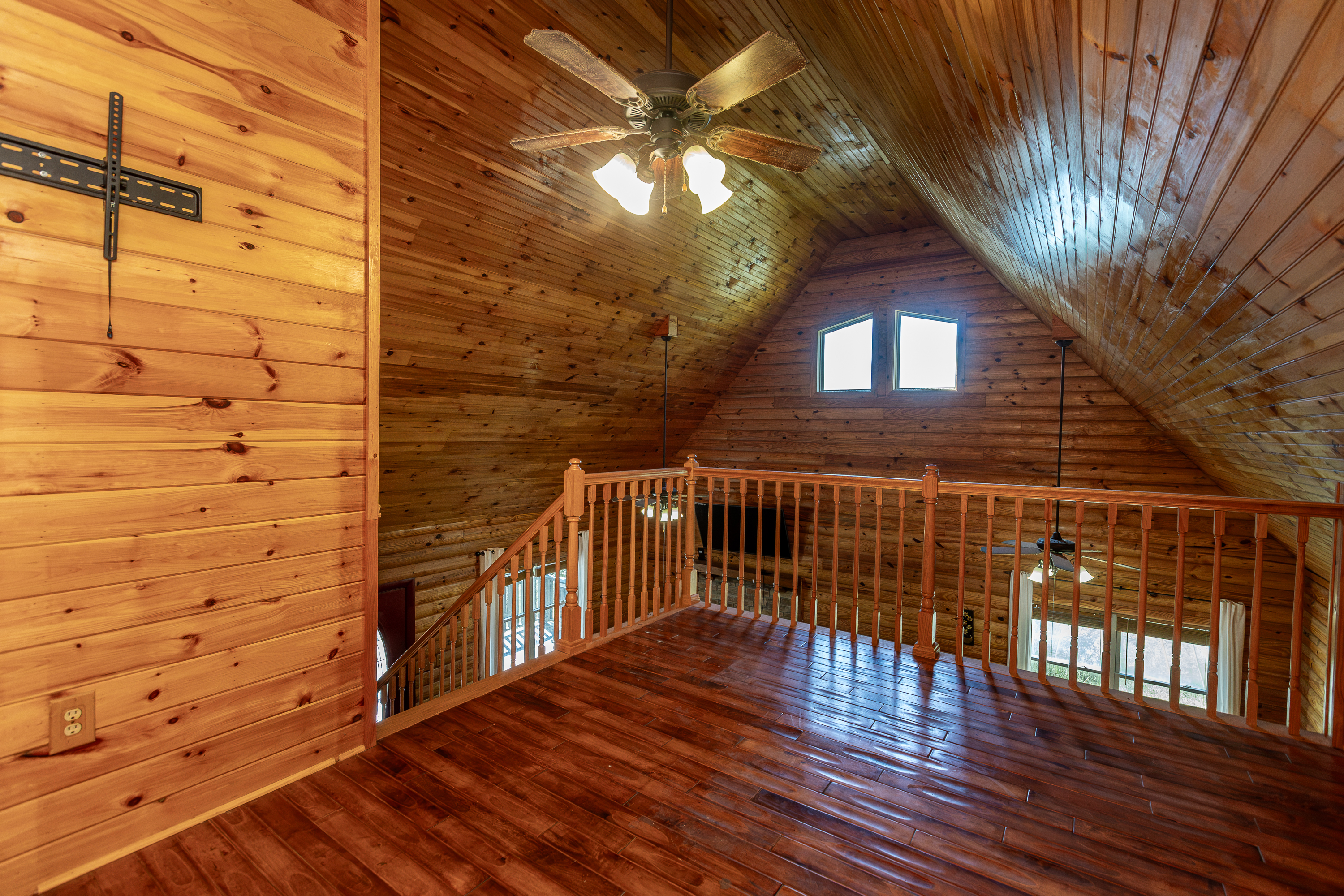 Loft bedroom with log walls