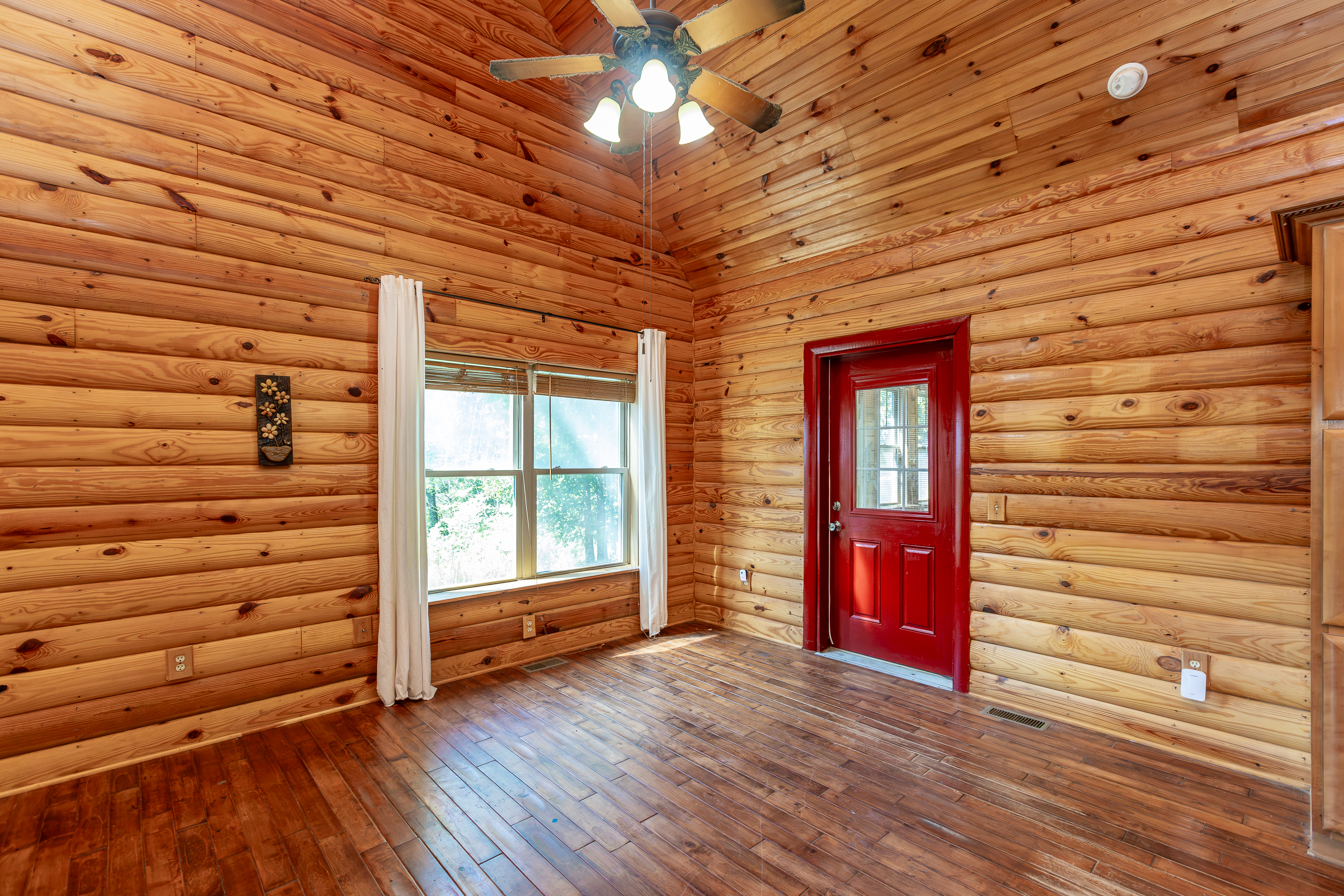 Kitchen with log walls and cabinetry