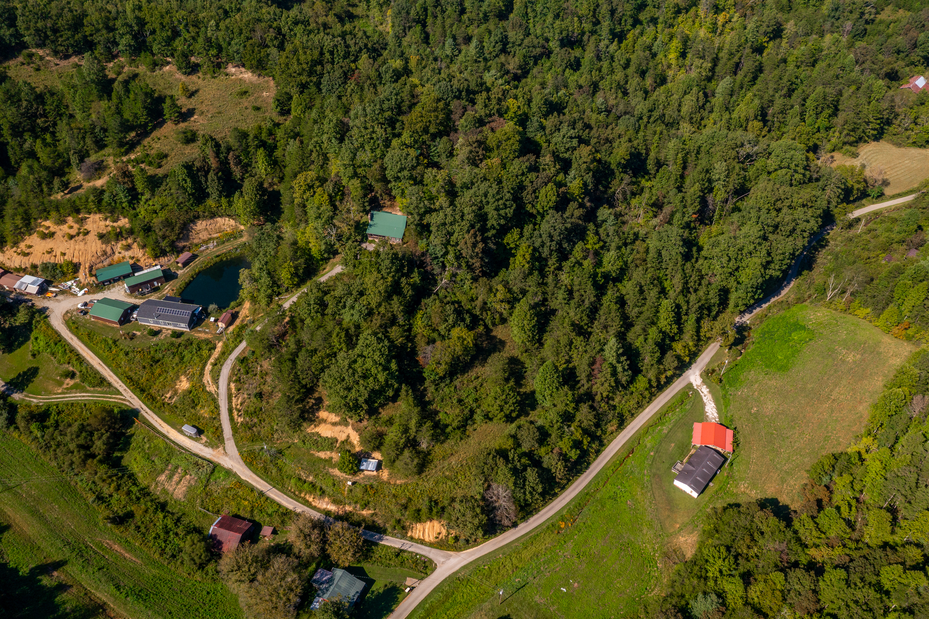 High aerial showing property and rolling mountain landscape